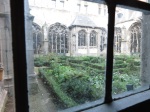 In the abbey complex at Middelburg, The Netherlands, a view of the herb garden through handmade glass. (Bobbie Faul-Zeitler, CC 3.0)